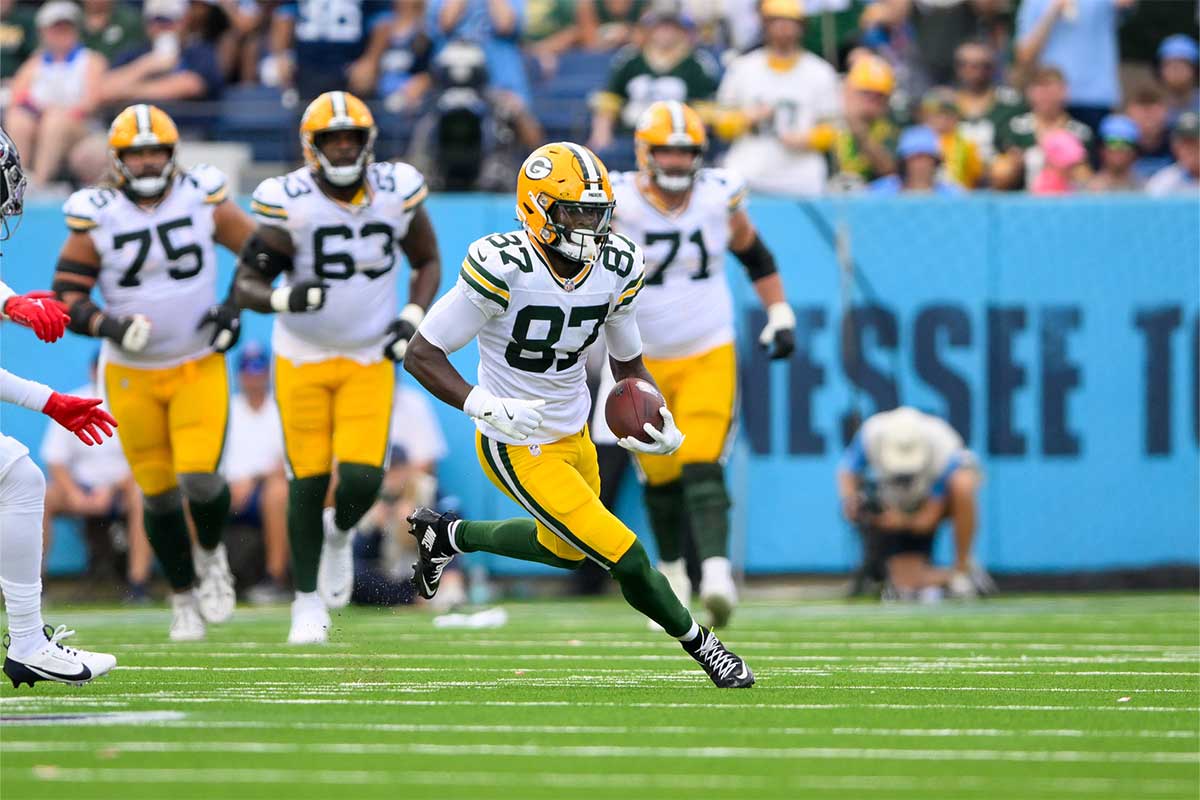 Green Bay Packers wide receiver Romeo Doubs (87) makes a catch and runs the ball against the Tennessee Titans during the first half at Nissan Stadium.