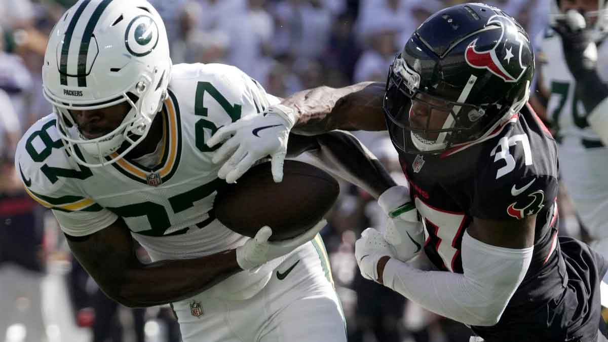 Green Bay Packers wide receiver Romeo Doubs (87) is tackled by Houston Texans cornerback D'Angelo Ross (37) during the fourth quarter of their game Sunday, October 20, 2024 at Lambeau Field in Green Bay, Wisconsin. The Green Bay Packers beat the Houston Texans 24-22.