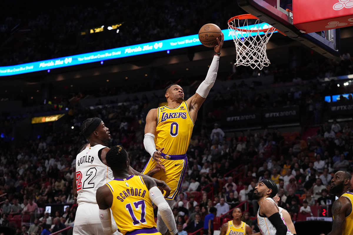 Los Angeles Lakers guard Russell Westbrook (0) puts up a shot around Miami Heat forward Jimmy Butler (22) during the first half at FTX Arena.