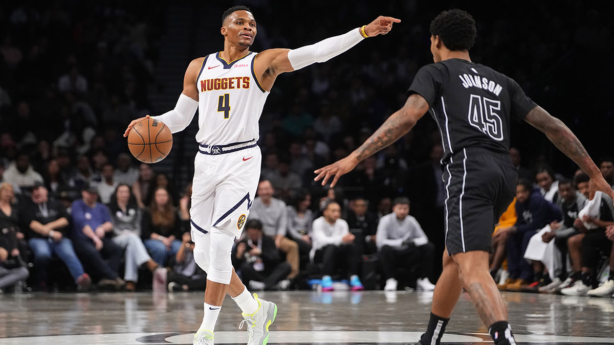 Denver Nuggets point guard Russell Westbrook (4) points as he dribbles the ball against Brooklyn Nets guard Keon Johnson (45) during the first half of the game at Barclays Center.