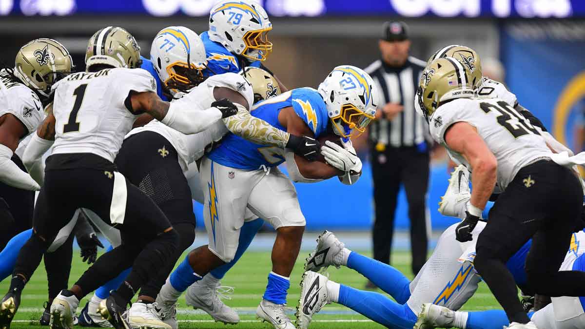 Los Angeles Chargers running back J.K. Dobbins (27) runs the ball against the New Orleans Saints during the second half at SoFi Stadium
