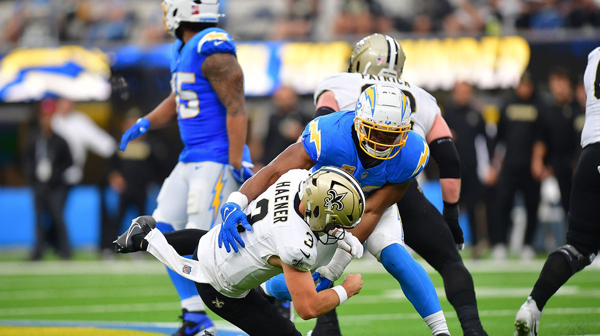 Los Angeles Chargers linebacker Khalil Mack (52) brings down New Orleans Saints quarterback Jake Haener (3) during the second half at SoFi Stadium.