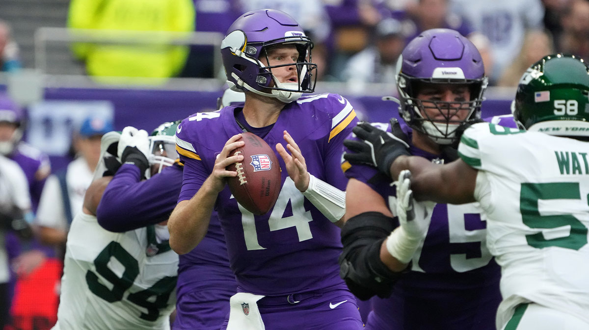 Minnesota Vikings quarterback Sam Darnold (14) throws the ball against the New York Jets in the first half at Tottenham Hotspur Stadium.