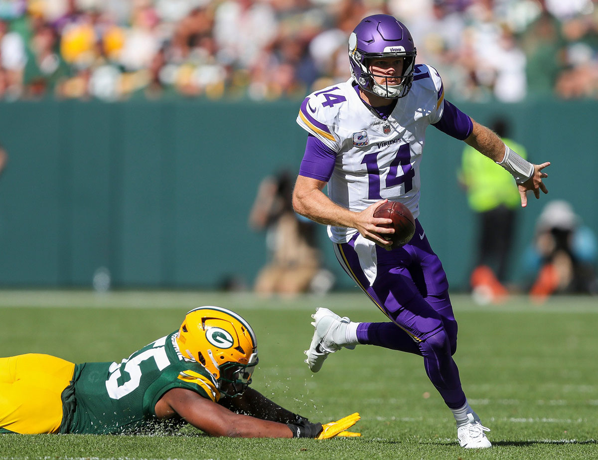 Minnesota Vikings quarterback Sam Darnold (14) escapes from Green Bay Packers defensive end Kingsley Enagbare (55) The Vikings won the game, 31-29.