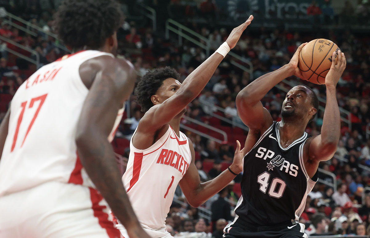 San Antonio Spurs forward Harrison Barnes (40) is guarded by Houston Rockets forward Amen Thompson (1) during the second quarter at Toyota Center.