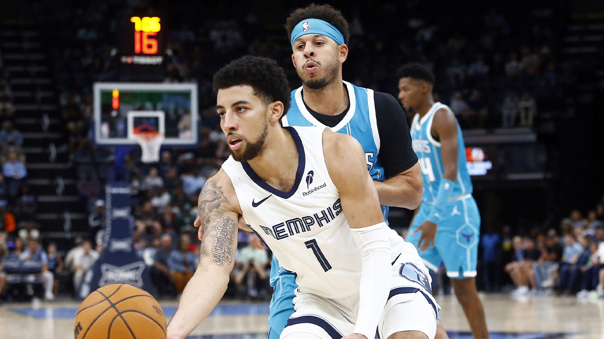 Memphis Grizzlies guard Scotty Pippen Jr. (1) passes the ball as Charlotte Hornets guard Seth Curry (30) defends during the second half at FedExForum.