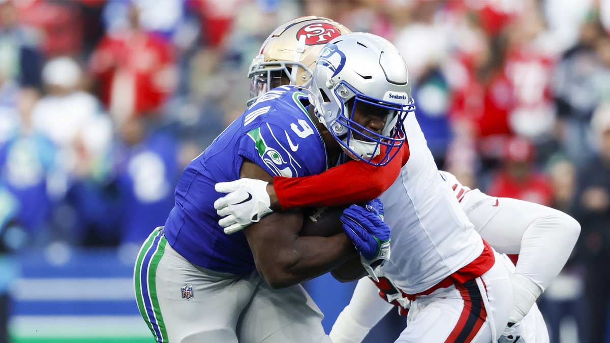 San Francisco 49ers cornerback Deommodore Lenoir (2) tackles Seattle Seahawks running back Kenneth Walker III (9) during the first quarter at Lumen Field