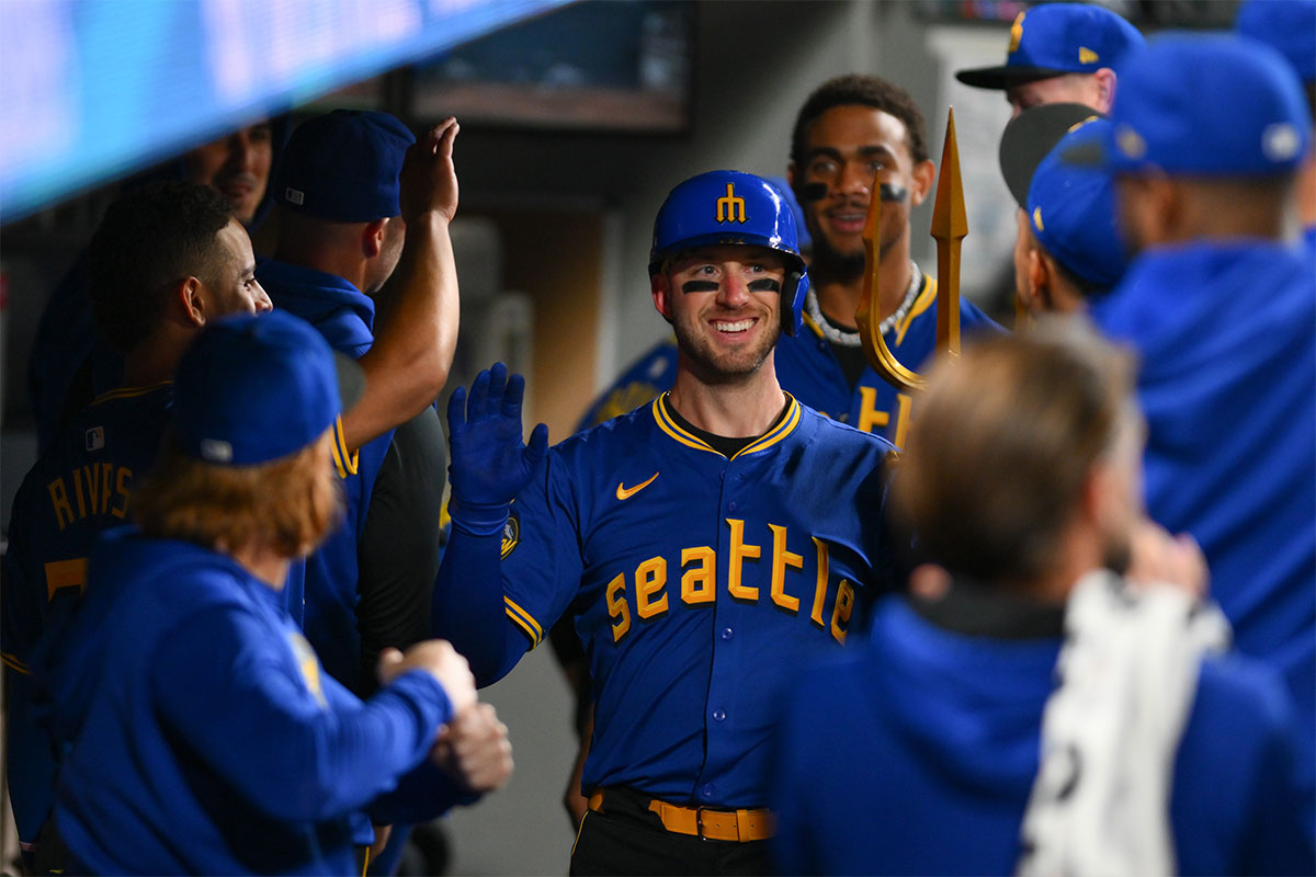 Seattle Mariners catcher Mitch Garver (18) celebrates in the dugout after hitting a home run against the Oakland Athletics during the second inning at T-Mobile Park.
