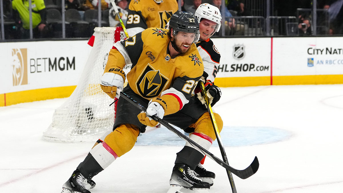 Vegas Golden Knights defenseman Shea Theodore (27) protects the puck from Anaheim Ducks center Isac Lundestrom (21) during the first period at T-Mobile Arena.