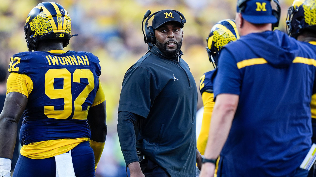 Michigan head coach Sherrone Moore talks to players at a timeout against USC during the second half at Michigan Stadium