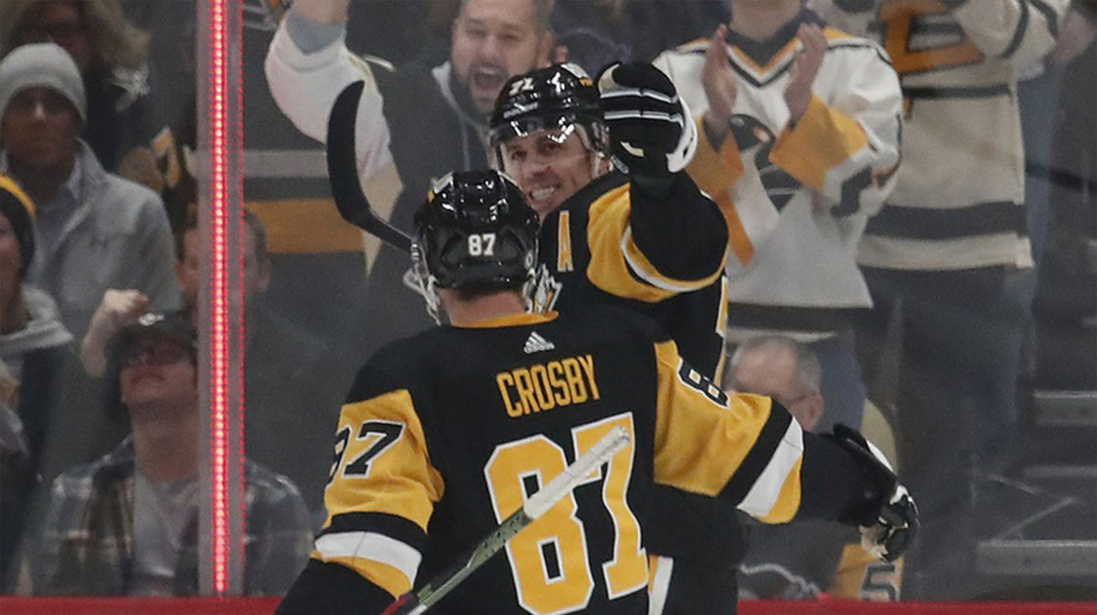 Pittsburgh Penguins center Evgeni Malkin (71) reacts with center Sidney Crosby (87) after scoring a power play goal against the St. Louis Blues during the second period at PPG Paints Arena.