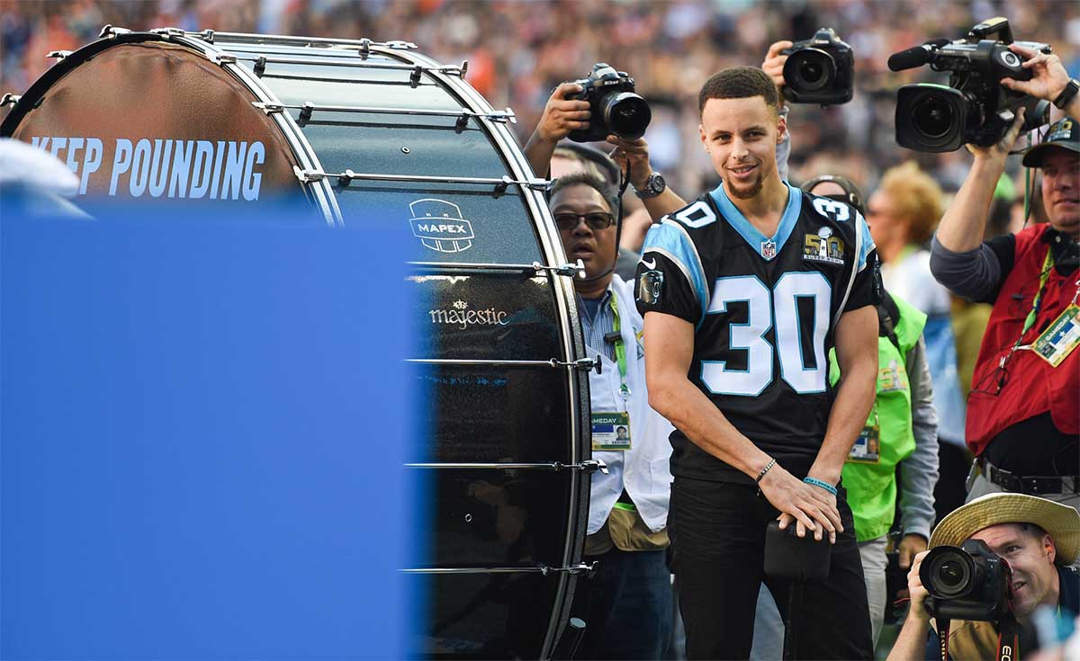 Golden State Warriors guard Stephen Curry prepares to pound the drum prior to the game between the Carolina Panthers and the Denver Broncos in Super Bowl 50 at Levi's Stadium.