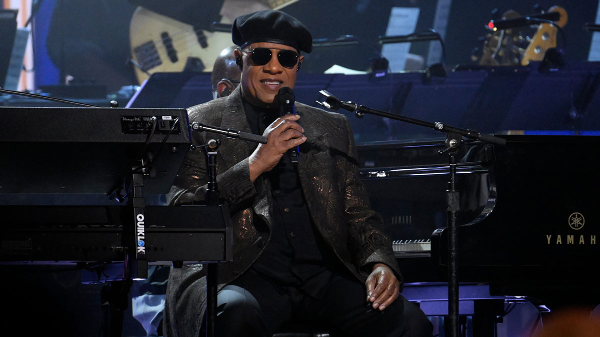 Stevie Wonder talking on stage at the Grammys.