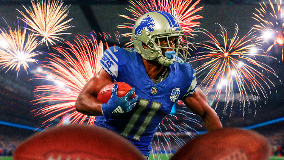 Lions Kalif Raymond in action carrying the ball with fireworks in the background.