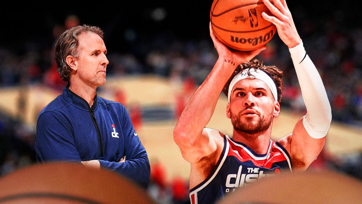 Brian Keefe looks at Corey Kispert, who's shooting a basketball