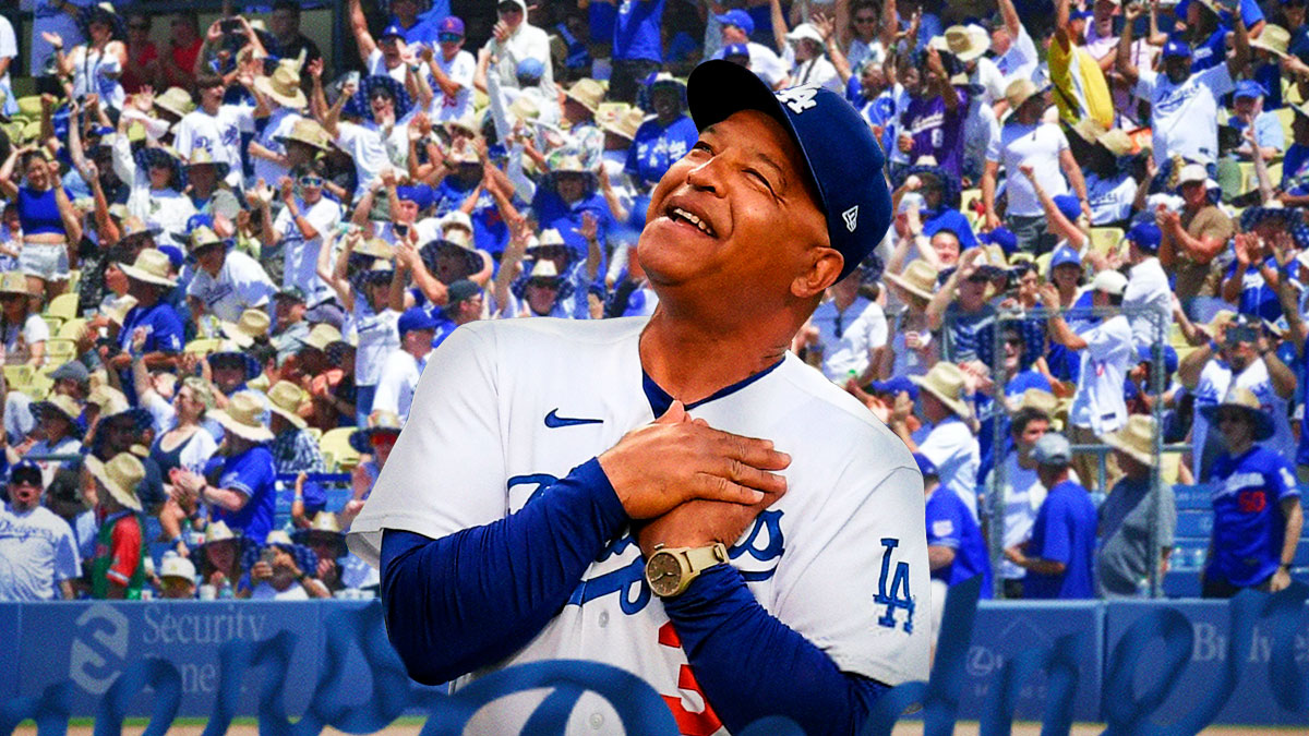 Los Angeles Dodgers manager Dave Roberts smiling - Dodgers fans cheering in background