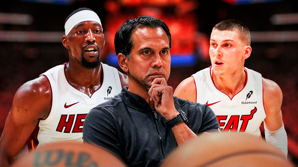 Miami Heat head coach Erik Spoelstra in the middle of Bam Adebayo and Tyler Herro in front of Kaseya Center.