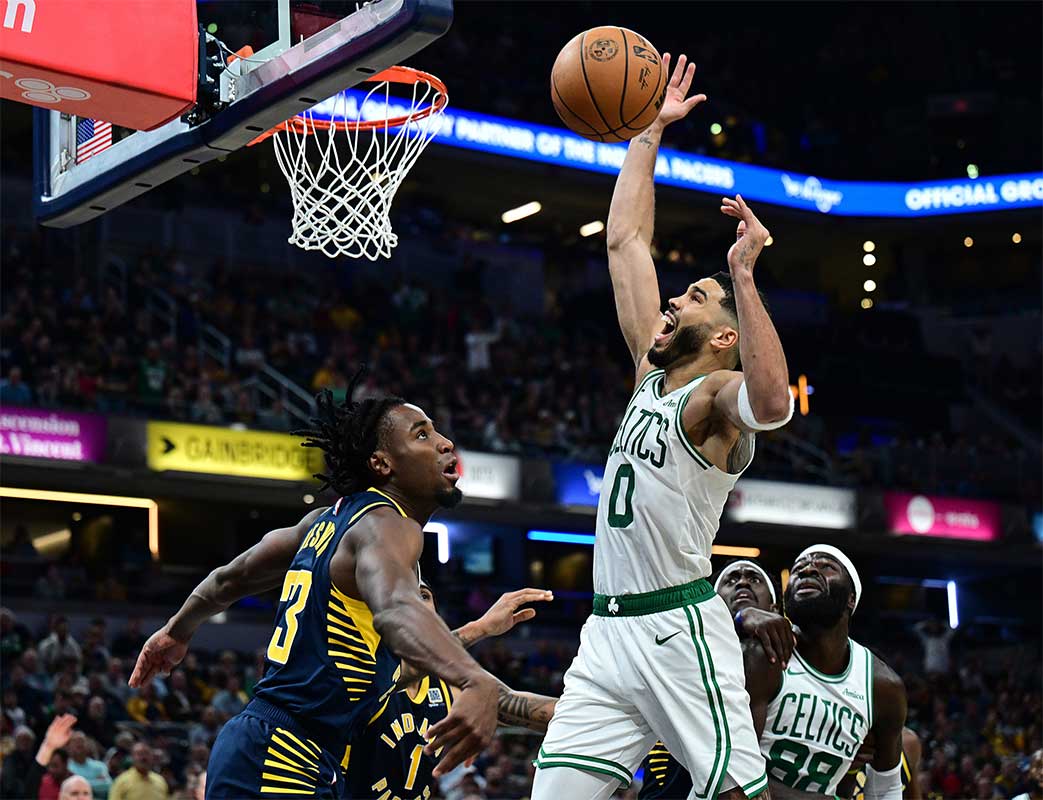 Boston Celtics forward Jayson Tatum (0) loses control of the ball in front of Indiana Pacers forward Aaron Nesmith (23) during the second half at Gainbridge Fieldhouse