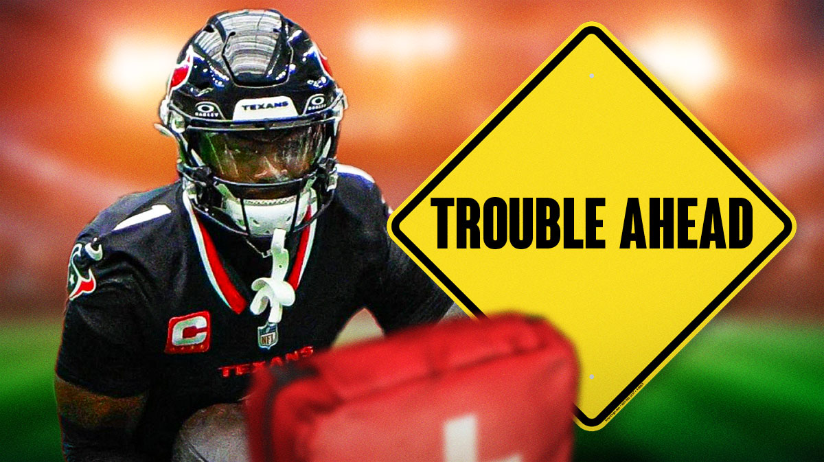 Texans' Stefon Diggs next to yellow sign that says TROUBLE AHEAD