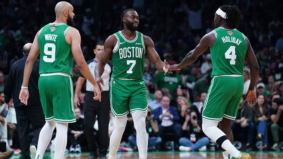  Boston Celtics guard Jaylen Brown (7), guard Jrue Holiday (4) and guard Derrick White (9) react after a play against the New York Knicks in the second half at TD Garden.