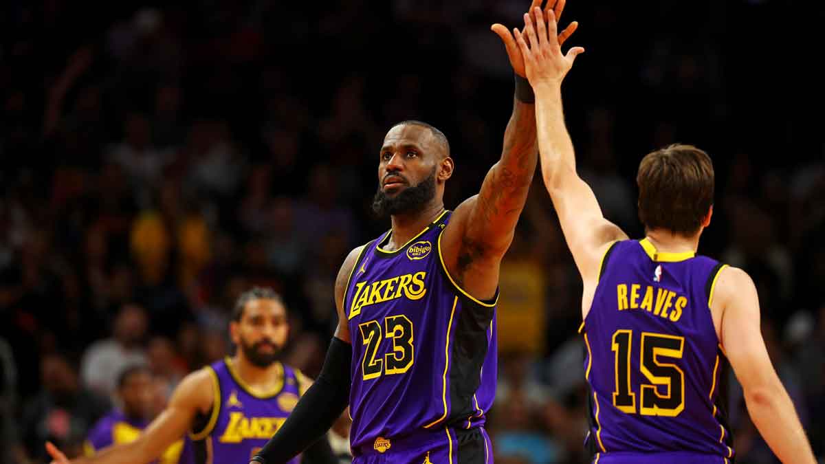 Los Angeles Lakers forward LeBron James (23) celebrates with guard Austin Reaves (15) after a play during the second half against the Phoenix Suns at Footprint Center. Trade rumors have connected the Lakers with several teams, including the Utah Jazz.