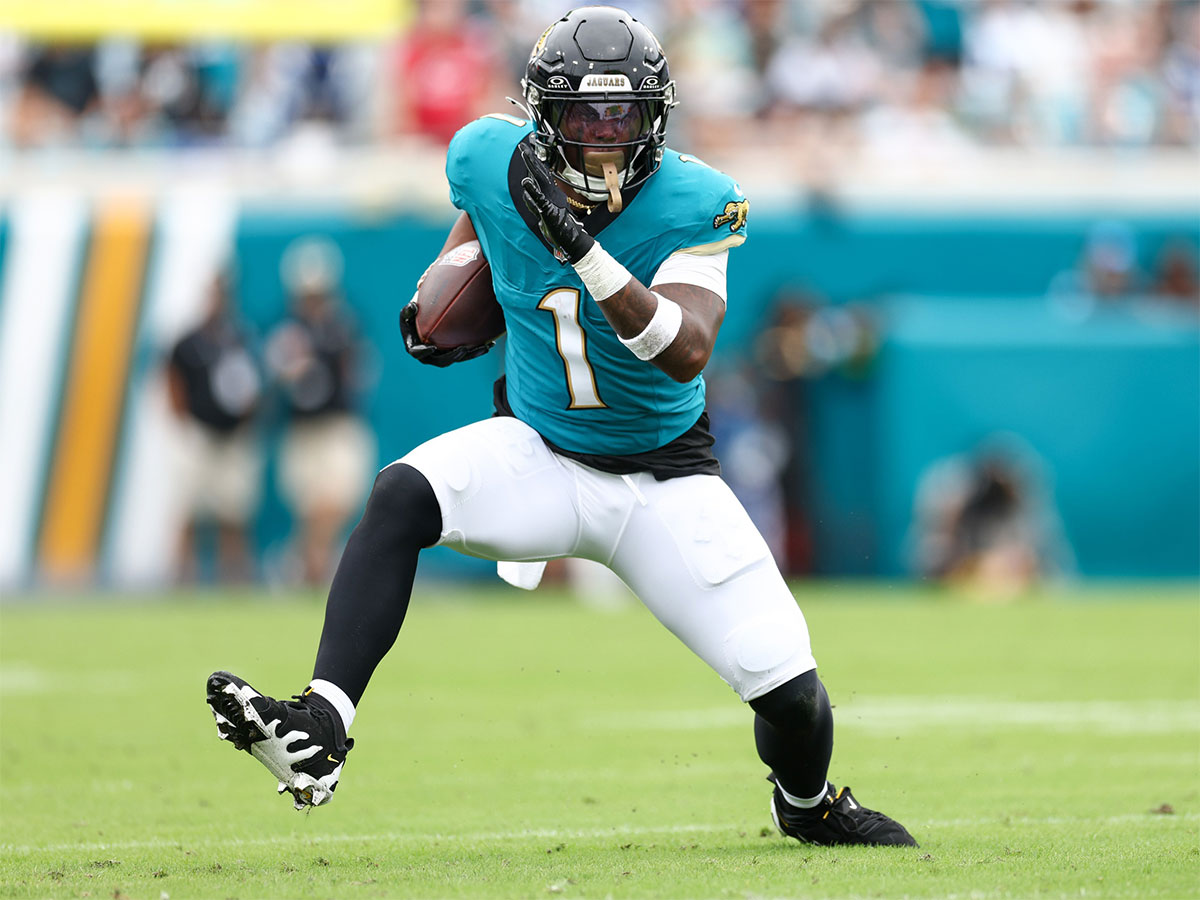 Oct 6, 2024; Jacksonville, Florida, USA; Jacksonville Jaguars running back Travis Etienne Jr. (1) runs with the ball against the Indianapolis Colts in the first quarter at EverBank Stadium.