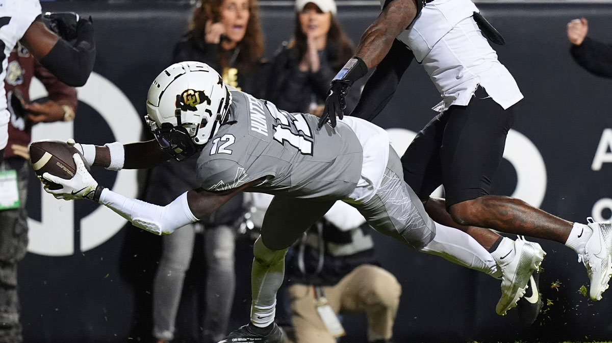 Colorado Buffaloes wide receiver Travis Hunter (12) dives for a touchdown in the second quarter against the Cincinnati Bearcats at Folsom Field.