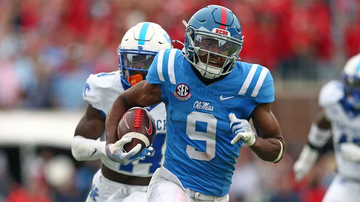 Mississippi Rebels wide receiver Tre Harris (9) runs after a catch for a first down as Kentucky Wildcats defensive back Jordan Lovett (25) pursues during the second half at Vaught-Hemingway Stadium.