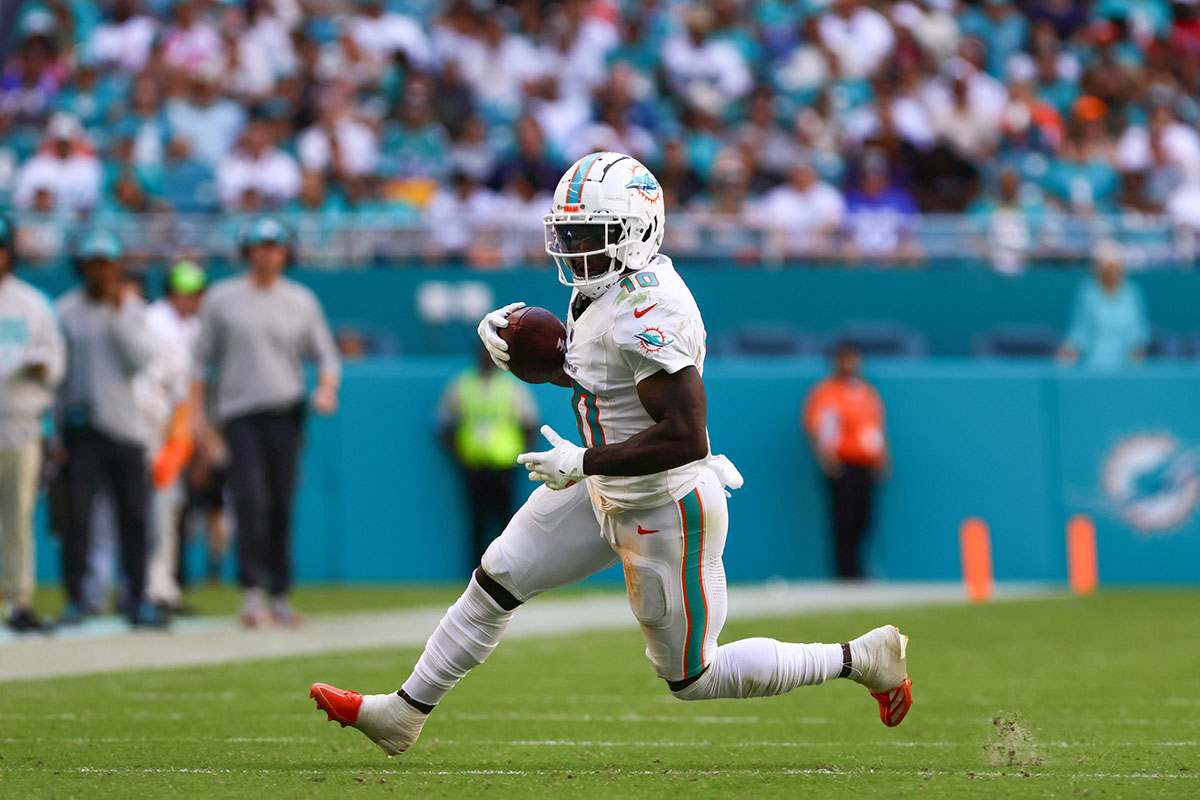 Oct 27, 2024; Miami Gardens, Florida, USA; Miami Dolphins wide receiver Tyreek Hill (10) runs with the football against the Arizona Cardinals during the fourth quarter at Hard Rock Stadium. 