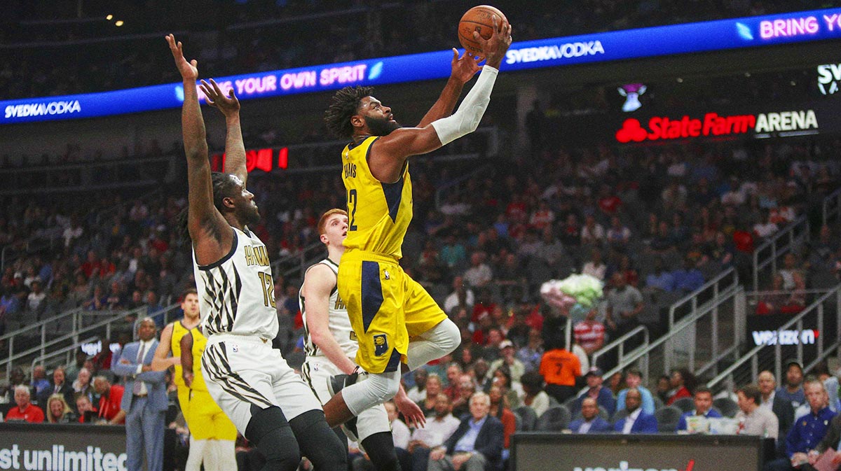 Back Indian Pasersa Tirik Evans (12) shoots against Atlant Hox in the first quarter at State Farm Arena.