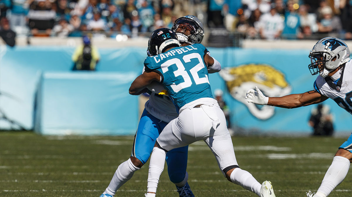 Dec 31, 2023; Jacksonville, Florida, USA; Jacksonville Jaguars corner back Tyson Campbell (32) tackles Carolina Panthers wide receiver Jonathan Mingo (15) during the first quarter at EverBank Stadium.