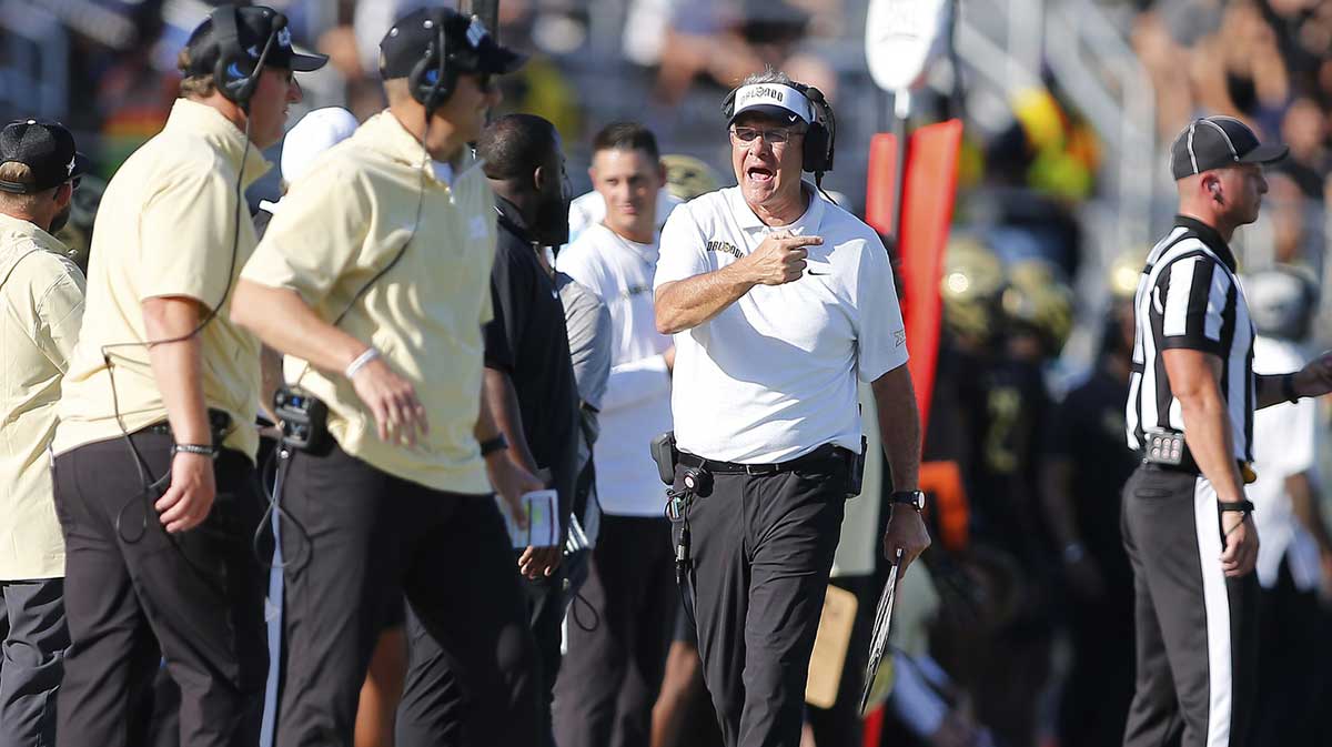 UCF football coach Gus Malzahn looking at the staff.