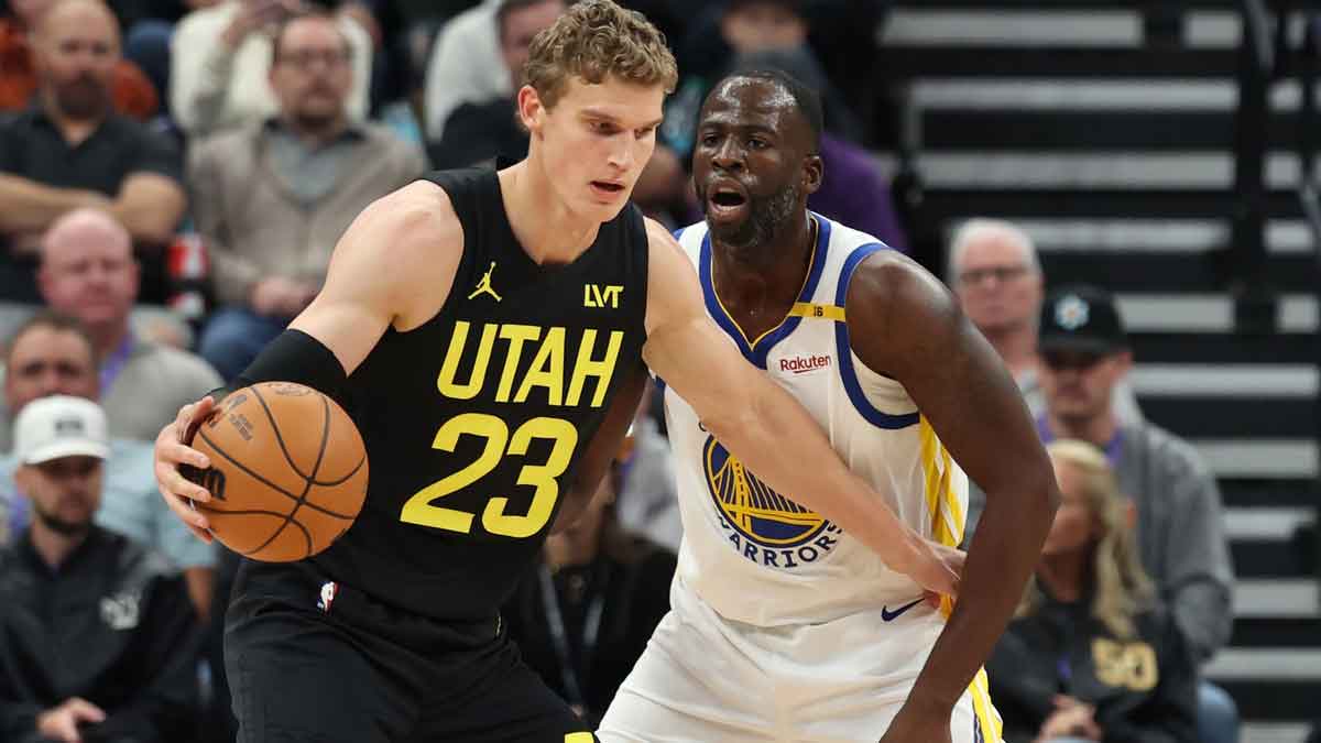 Utah Jazz forward Lauri Markkanen (23) posts up on Golden State Warriors forward Draymond Green (23) during the first quarter at Delta Center. 