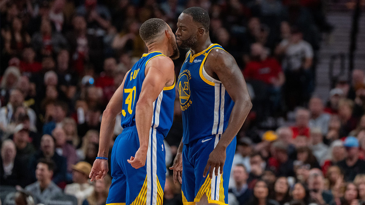 Warriors point guard Stephen Curry (30) and power forward Draymond Green (23) celebrate during the second half against the Portland Trailblazers at Moda Center