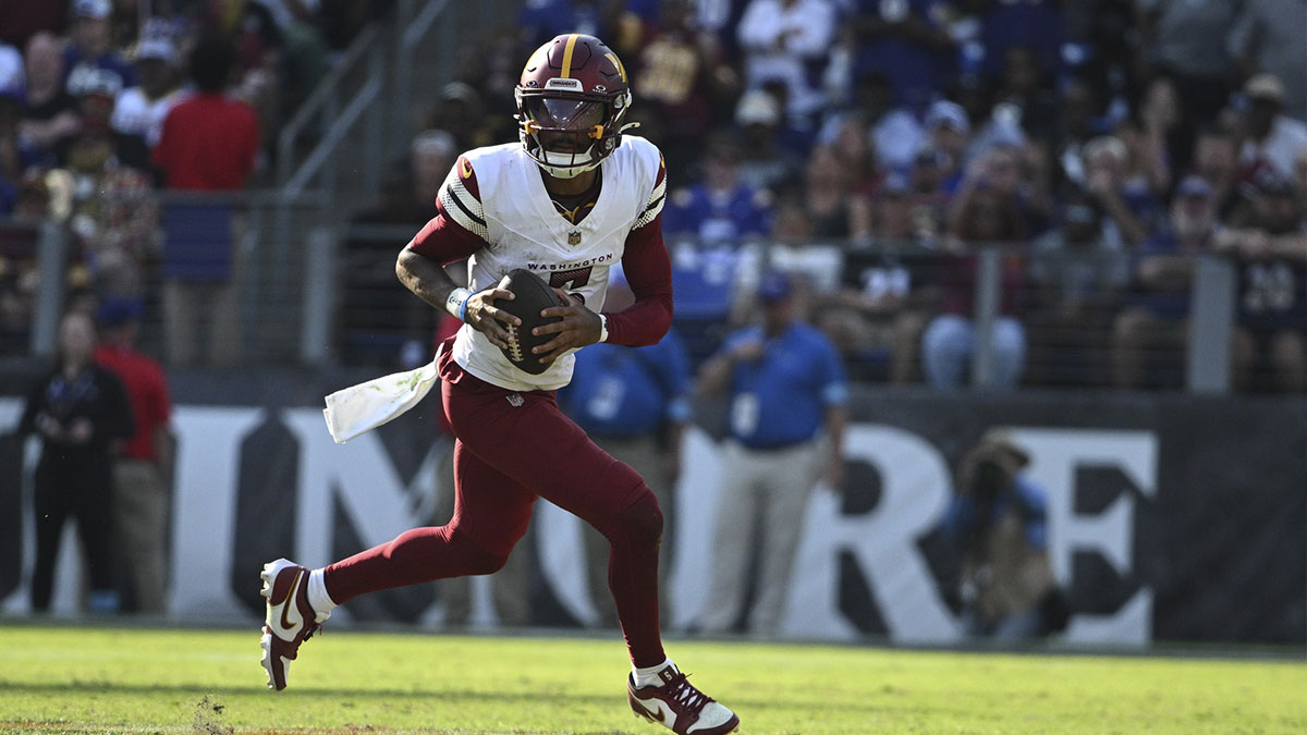 Washington Commanders quarterback Jayden Daniels (5) rolls out to pass during the second half against the Baltimore Ravens at M&T Bank Stadium.