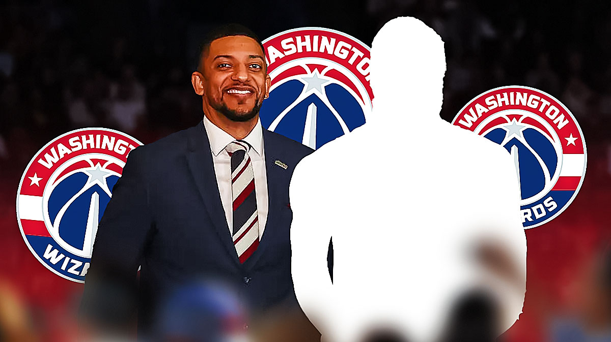 Will Dawkins smiles at silhouette surrounded by Wizard logos