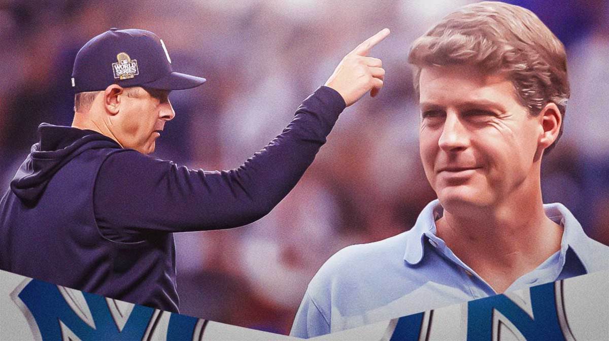 Hal Steinbrenner looks at a sad Aaron Boone