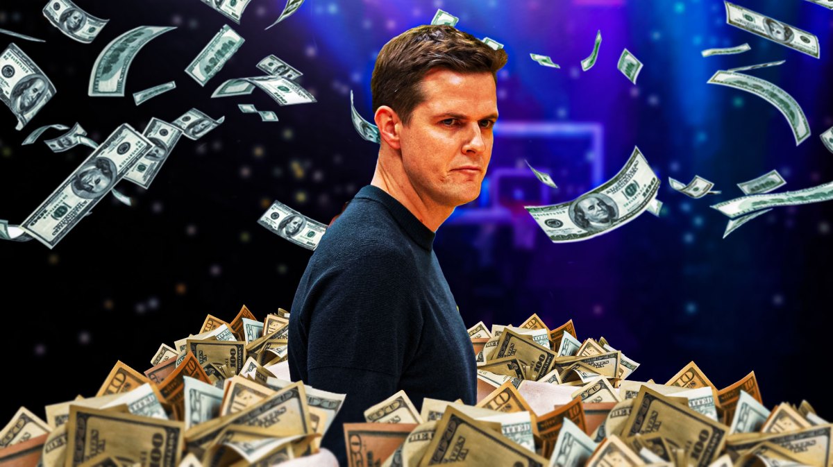 Will Hardy surrounded by piles of cash.