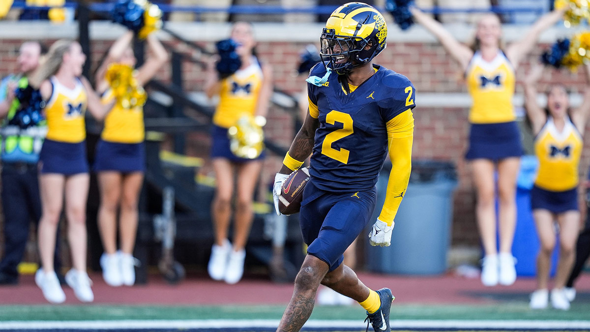 Michigan defensive back Will Johnson celebrates a touchdown after intercepting USC quarterback Miller Moss during the second half at Michigan Stadium in Ann Arbor on Saturday, Sept. 21, 2024.