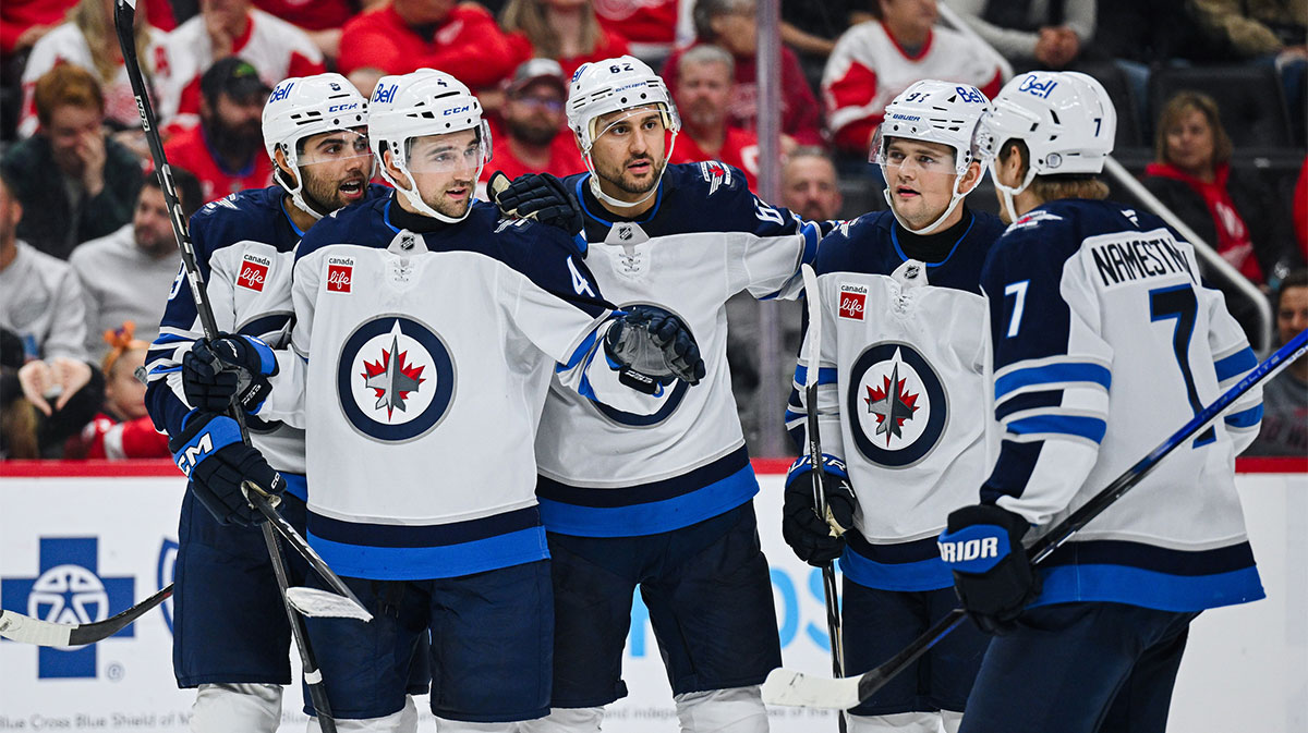 Winnipeg Jets defenseman Neal Pink (4) celebrates his goal during the third period against the Detroit Red Wings at Little Caesars Arena.