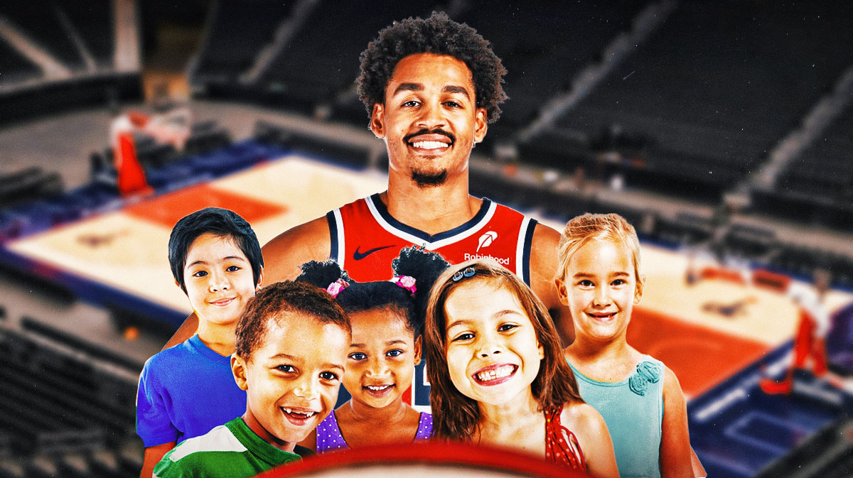 Jordan Poole in Wizards jersey smiling and hanging out with kids