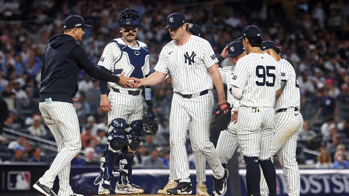 New York Yankees manager Aaron Boone (17) relieves New York Yankees pitcher Gerrit Cole (45) during the sixth inning against the Kansas City Royals during game one of the ALDS for the 2024 MLB Playoffs at Yankee Stadium