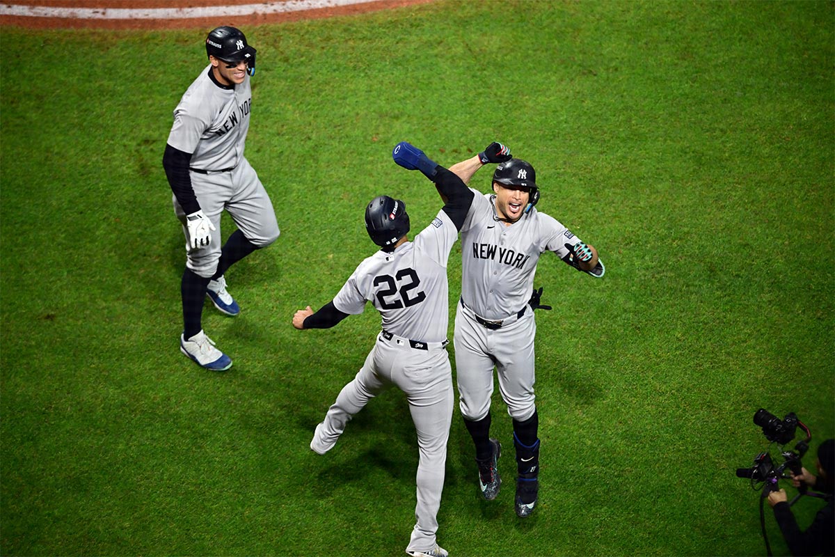 New York Yankees designated hitter Giancarlo Stanton (27) celebrates after hitting a three run home run with outfielder Juan Soto (22) and outfielder Aaron Judge (99) in the sixth inning against the Cleveland Guardians during game four of the ALCS for the 2024 MLB playoffs at Progressive Field