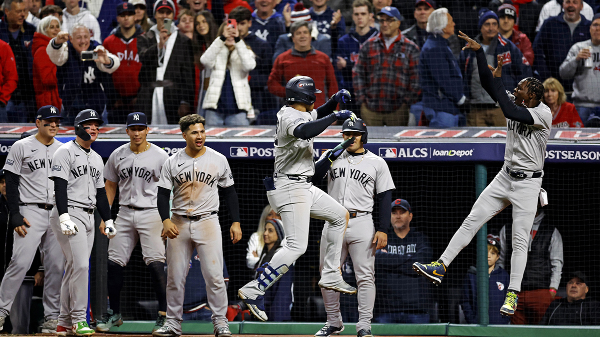 New York Yankees outfielder Juan Soto (22) celebrates with his teammates after hitting a three run home run during the tenth inning against the Cleveland Guardians during game five of the ALCS for the 2024 MLB playoffs at Progressive Field.