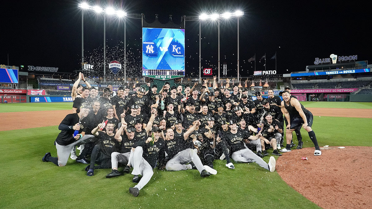 New York Yankees celebrate on the field following a win over the Kansas City Royals during game four of the ALDS for the 2024 MLB Playoffs at Kauffman Stadium.