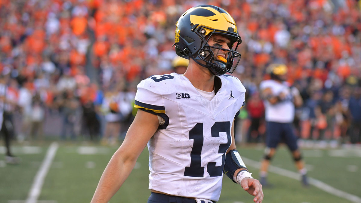 Michigan Wolverines quarterback Jack Tuttle (13) reacts after turning over possession of the ball against the Illinois Fighting Illini during the second half at Memorial Stadium.