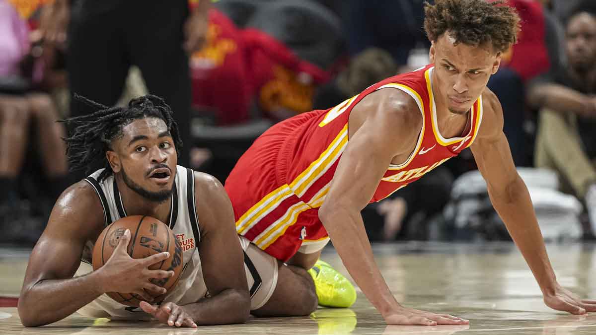 Brooklyn Nets guard Cam Thomas (24) and Atlanta Hawks guard Dyson Daniels (5) battle for the ball during the second half at State Farm Arena.