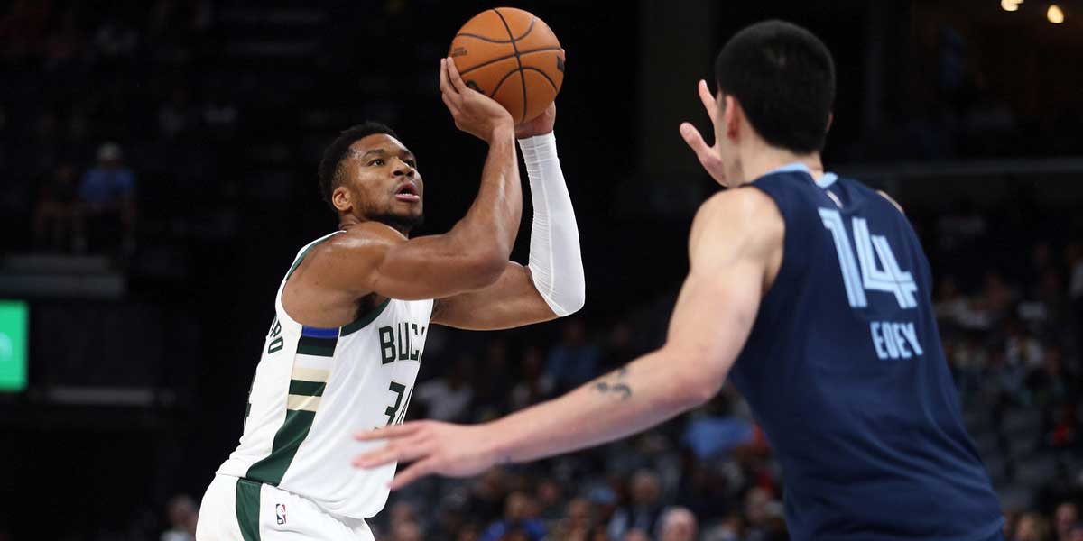 Milwaukee Bucks forward Giannis Antetokounmpo (34) shoots as Memphis Grizzlies center Zach Edey (14) defends during the first half at FedExForum.