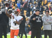 Cleveland Browns quarterback Deshaun Watson (4) throws a practice pass as head coach Kevin Stefanski (right) watches before playing the Pittsburgh Steelers at Acrisure Stadium.