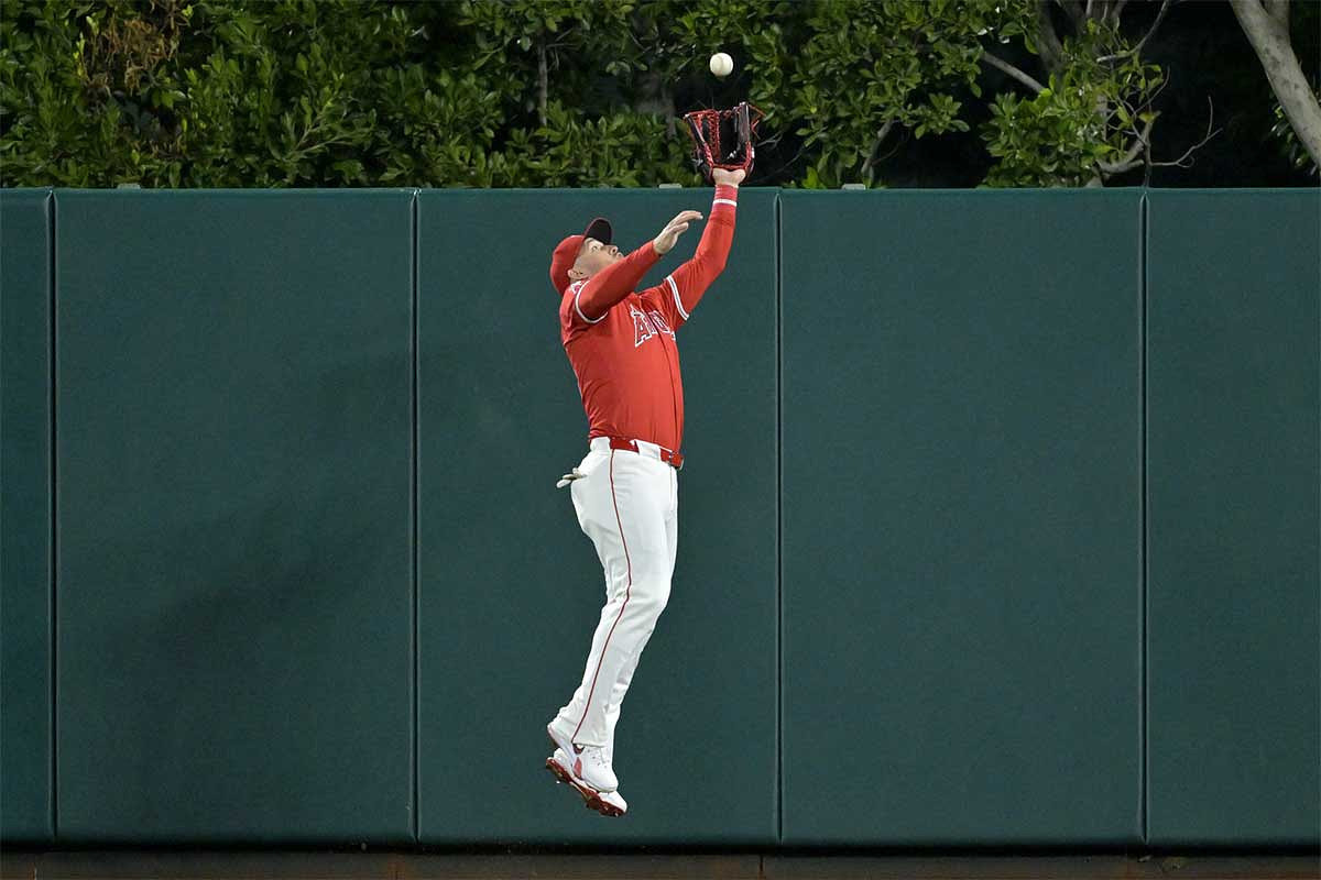 Los Angeles Angels outfielder Mike Trout (27) makes a leaping catch at the wall off a fly ball hit by Boston Red Sox outfielder Jarren Duran (16) in the eighth inning at Angel Stadium.